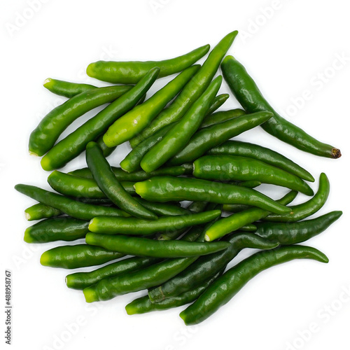 A pile of green chili pepper without stalk chili pole on white background. spot focus.
