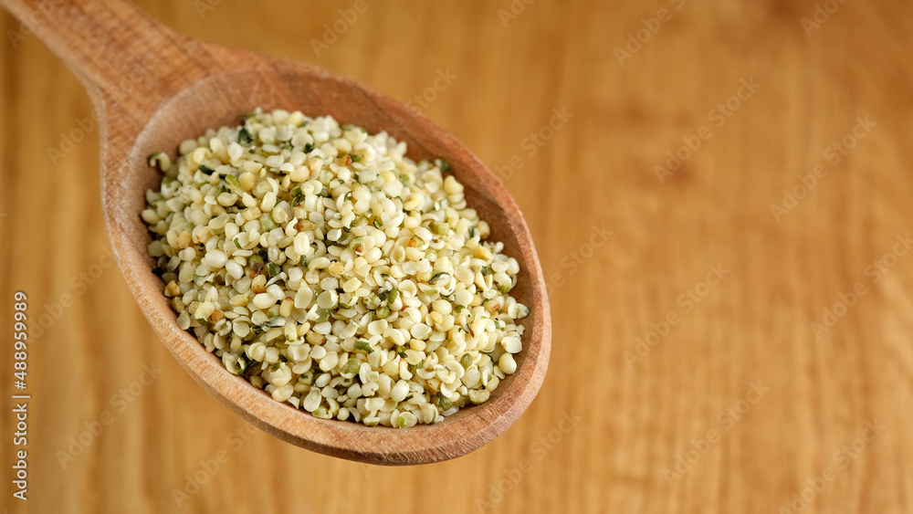 Organic hemp seeds in wooden spoon. Superfood hemp seeds Organic hemp seeds in wooden spoon. Superfood hemp seeds