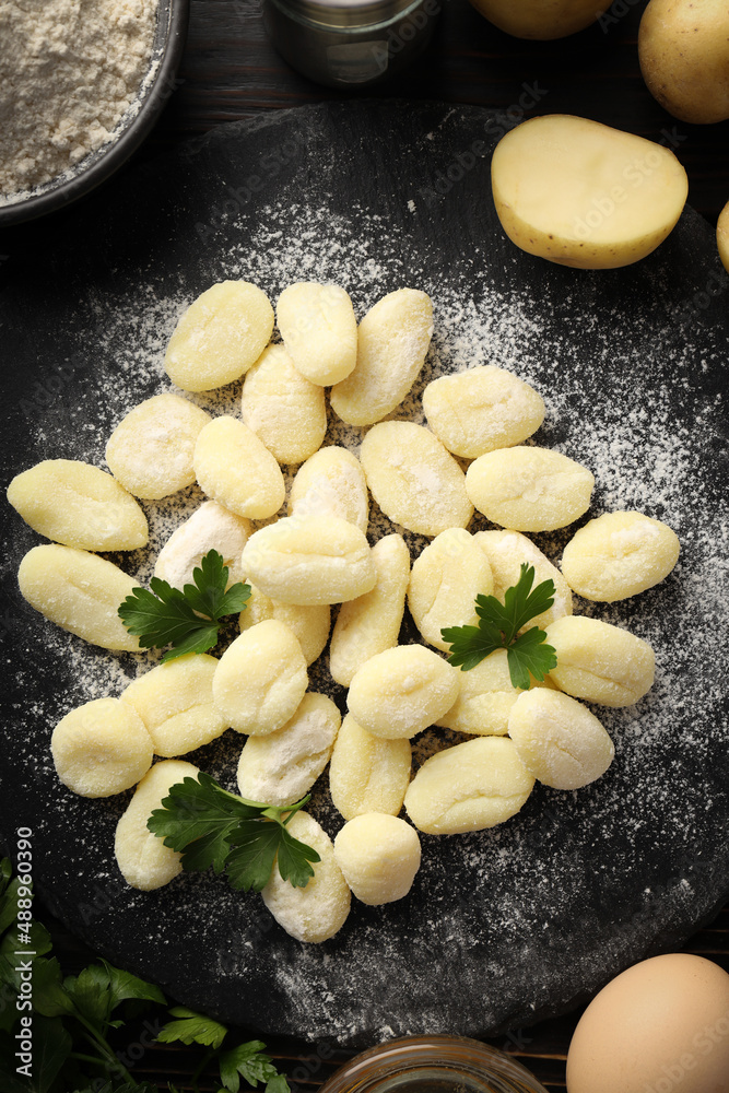 Concept of cooking with raw potato gnocchi, top view Concept of cooking with raw potato gnocchi, top view