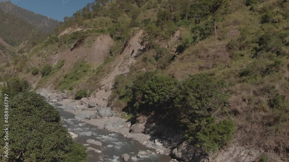 river flowing with mountain water in remote tropical region surrounded by trees in benguet philippines slow approaching aerial river flowing with mountain water in remote tropical region surrounded by trees in benguet philippines slow approaching aerial