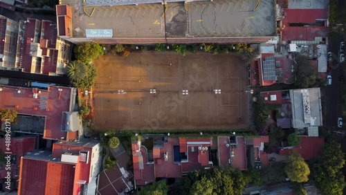 Top Down Shot Flying Away from a Beautiful Tennis Sports Club and Showing its Surroundings in the Morning in Mexico City photo