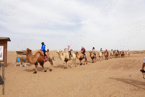 Tourists riding camels in Alxa desert, Inner Mongolia