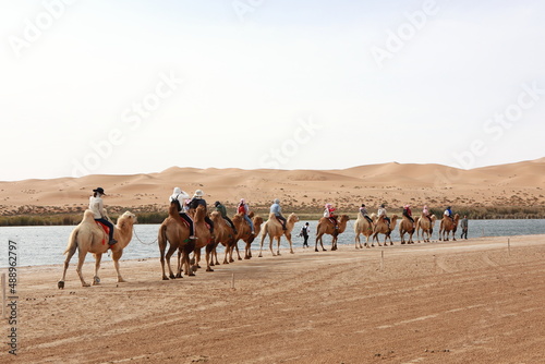 Tourists riding camels in Alxa desert, Inner Mongolia