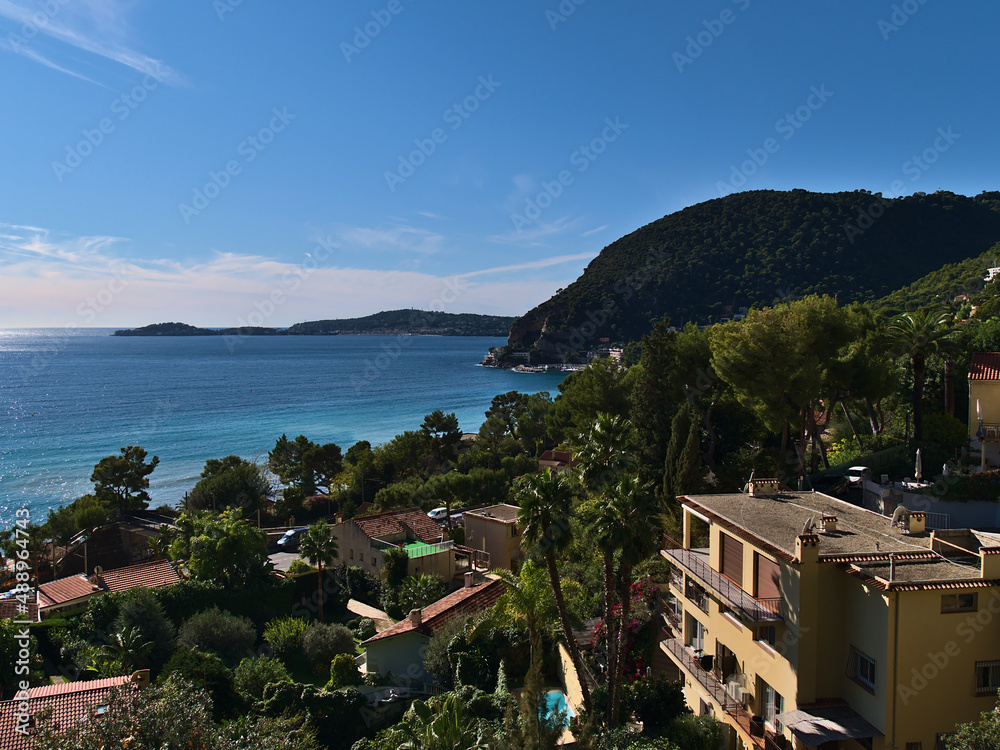Beautiful view of small village Eze-sur-Mer at the French Riviera on the mediterranean coast on sunny day in autumn with apartment building on hill.