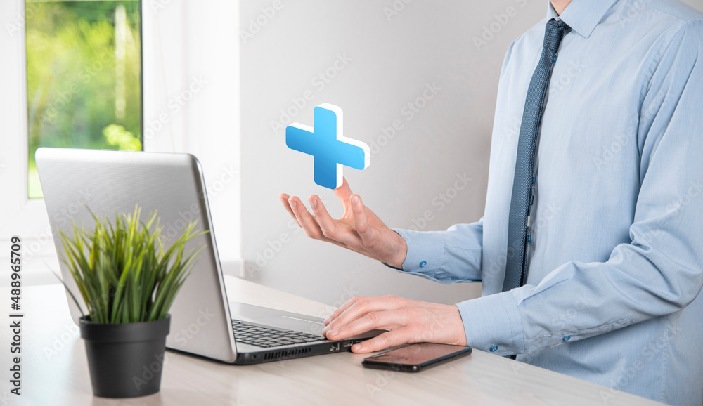 Businessman hold 3D plus icon, man hold in hand offer positive thing such as profit, benefits, development, CSR represented by plus sign.The hand shows the plus sign Businessman hold 3D plus icon, man hold in hand offer positive thing such as profit, benefits, development, CSR represented by plus sign.The hand shows the plus sign