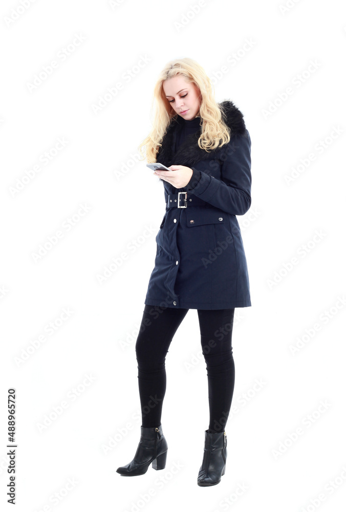 full length portrait of blonde woman wearing long winter coat. and casual clothes. standing pose, isolated on a white studio background. full length portrait of blonde woman wearing long winter coat. and casual clothes. standing pose, isolated on a white studio background.