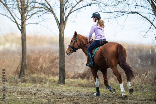 Young girl riding a horse