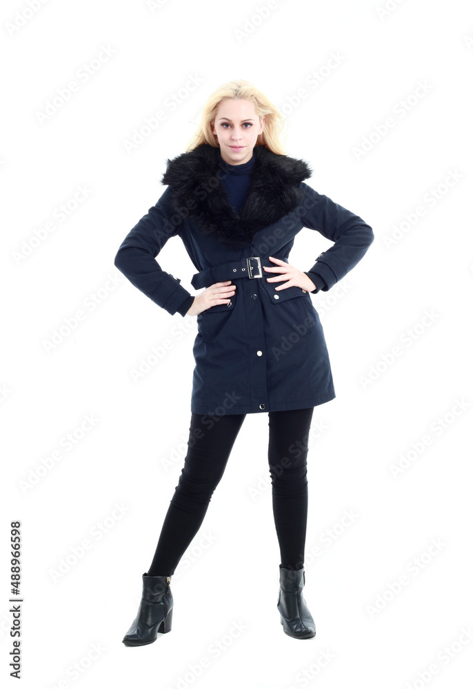Fototapeta premium full length portrait of blonde woman wearing long winter coat. and casual clothes. standing pose, isolated on a white studio background.