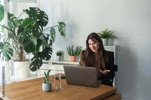 Young business woman psychotherapist doctor having online psychotherapy therapy with her patient on video call on the laptop computer while she working at home in the home office, telemedicine concept