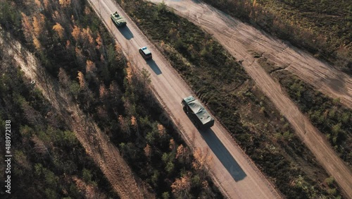 A military convoy is moving along the road. Aerial view. photo