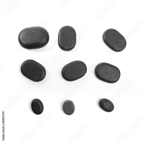 black spa stones isolated on white background .