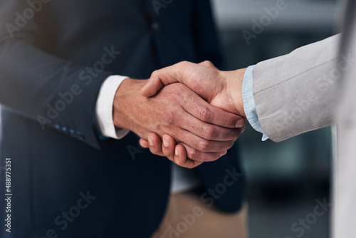 It all boils down to trust. Cropped shot of two businessmen shaking hands in a modern office. © Tamani C/peopleimages.com