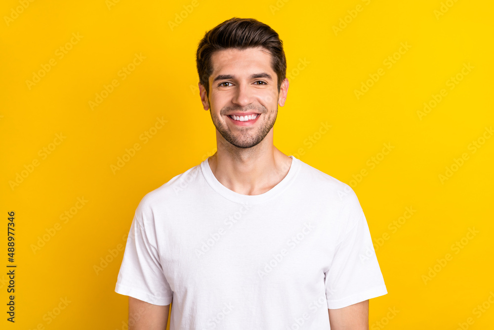Photo of cheerful nice attractive man toothy beaming smile wear white t-shirt isolated yellow color background Photo of cheerful nice attractive man toothy beaming smile wear white t-shirt isolated yellow color background