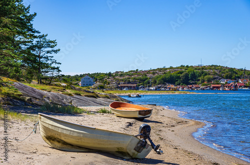 Two boats lie ashore on the North shore of Southkoster Island (Sydkoster) and beautiful view of the North Koster Island (Nordkoster), Bohuslän, Västra Götalands län, Sweden. photo