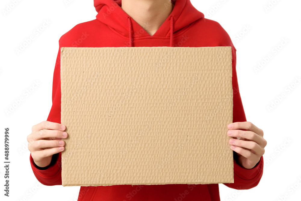 Closeup of man hands holding blank cardboard placard, isolated on white background. Teenage boy dressed red hoodie holding empty banner for your text.