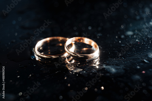 Holding wedding rings. Noble metal jewellery for married couples.Wedding ceremony and planing.Holding traditional bridal commitment jewellery.Golden ring for bride and groom.Marriage proposal exchange