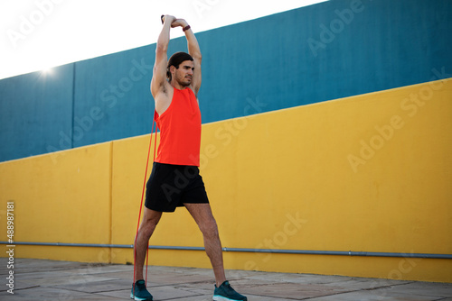 Young sexy man training outside. Fit handsome man doing exercise