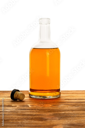 Bottle of alcohol with a cork on a white background.