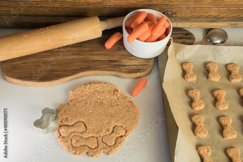 Dog biscuit dough with cookie cutter. Bone shaped. 