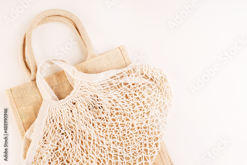 A variety of eco bags on a yellow background.Sustainable lifestyle.Eco Bags.Zero waste minimal composition with tring and canvas bags for storage.Zero waste, eco friendly shopping. Top view, flat lay.