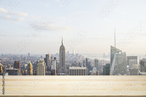 Empty table top made of wooden dies with New York city view at daytime on background, template