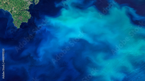 Aerial turquoise ocean photo from clear sky, top view of sea texture background, 16:9 ratio wallpaper, blooms of phytoplankton in the waters around England, Elements of this image furnished by NASA.