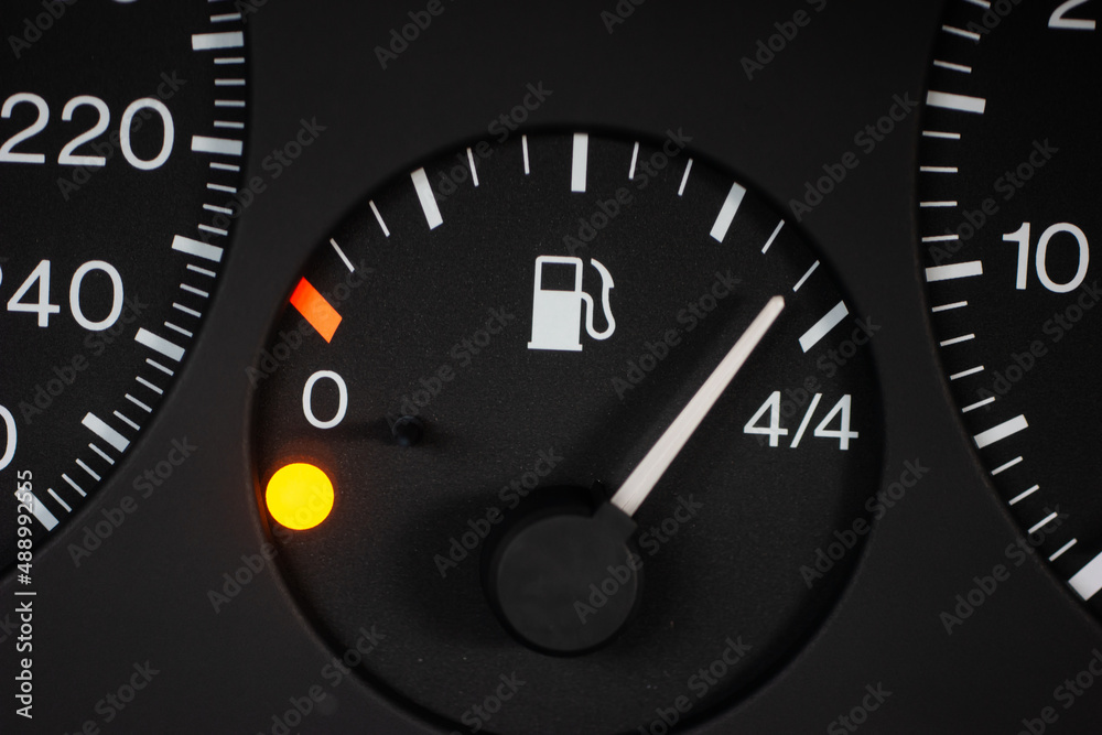 Car fuel gauge scale with orange reserve light on. Close up macro shot, no people Car fuel gauge scale with orange reserve light on. Close up macro shot, no people