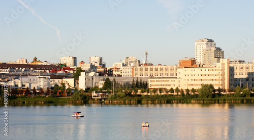 The Lake Nizhny Kaban. Kazan, Tatarstan, Russia: July 14 2021. The embankment of the Lower Kaban Lake. Tourists are walking and boating. Photo with copy space. Panoramic view of the embankment © Elena