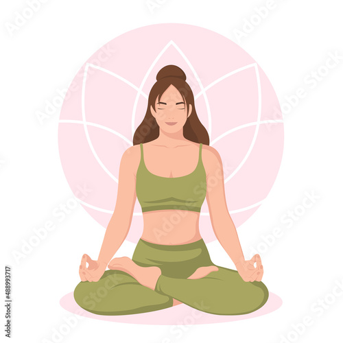 Meditating woman in green in lotus pose. Yoga