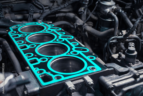 Short block with installed cylinder head gasket. Repair of a turbocharged diesel engine in a car workshop. Close up. Blur effect.