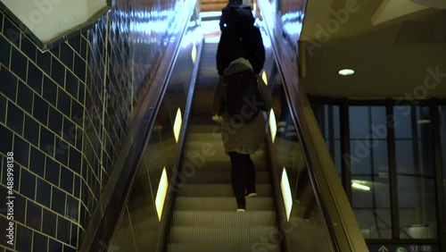 Anonymous people on e scalator in airport, station or shopping mall moving staircase going up
 photo