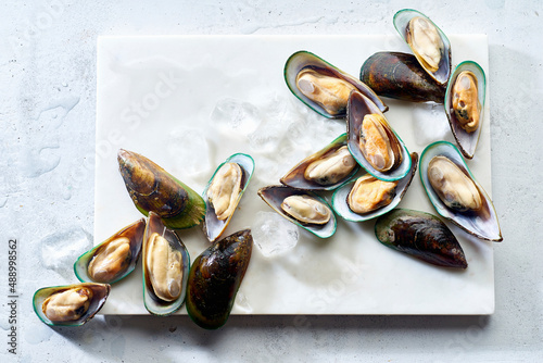 Raw green lipped mussels on a marble board photo
