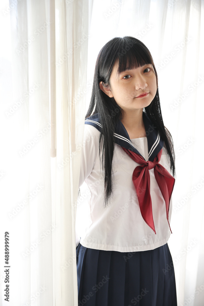 Asian female high school student sitting with cosmos flower garden Asian female high school student sitting with cosmos flower garden