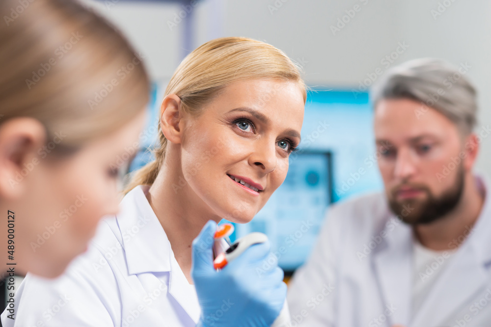 Professional team of scientists is working on a vaccine in a modern scientific research laboratory. Genetic engineer workplace. Future technology and science. Professional team of scientists is working on a vaccine in a modern scientific research laboratory. Genetic engineer workplace. Future technology and science.