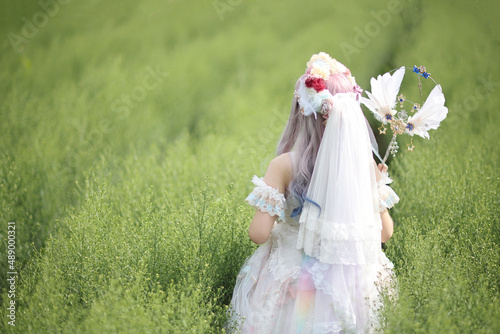 Canvas Print Beautiful young woman with white lolita dress with flowers garden Japanese fashi