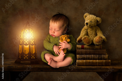 Baby on shelf with lantern Fototapeta