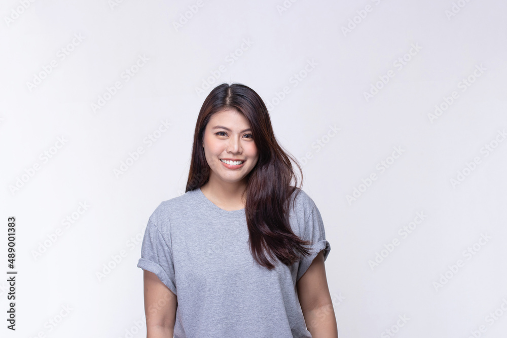 Image of feeling smile and happy. Cheerful young asian woman with brunette long hair in casual shirt smiling with teeth on white. Female face expressions and emotions concept. Image of feeling smile and happy. Cheerful young asian woman with brunette long hair in casual shirt smiling with teeth on white. Female face expressions and emotions concept.