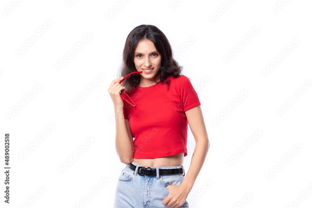 Attractive beautiful young woman smiling cheerfully with long hair brunette wearing red casual t shirt fashion lifestyle portrait pretty woman in sunglasses posing isolated on white background. Attractive beautiful young woman smiling cheerfully with long hair brunette wearing red casual t shirt fashion lifestyle portrait pretty woman in sunglasses posing isolated on white background.