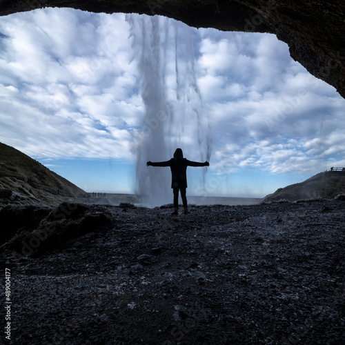 Silhouette of a man in front of the Seljalandsfoss waterfall in Iceland