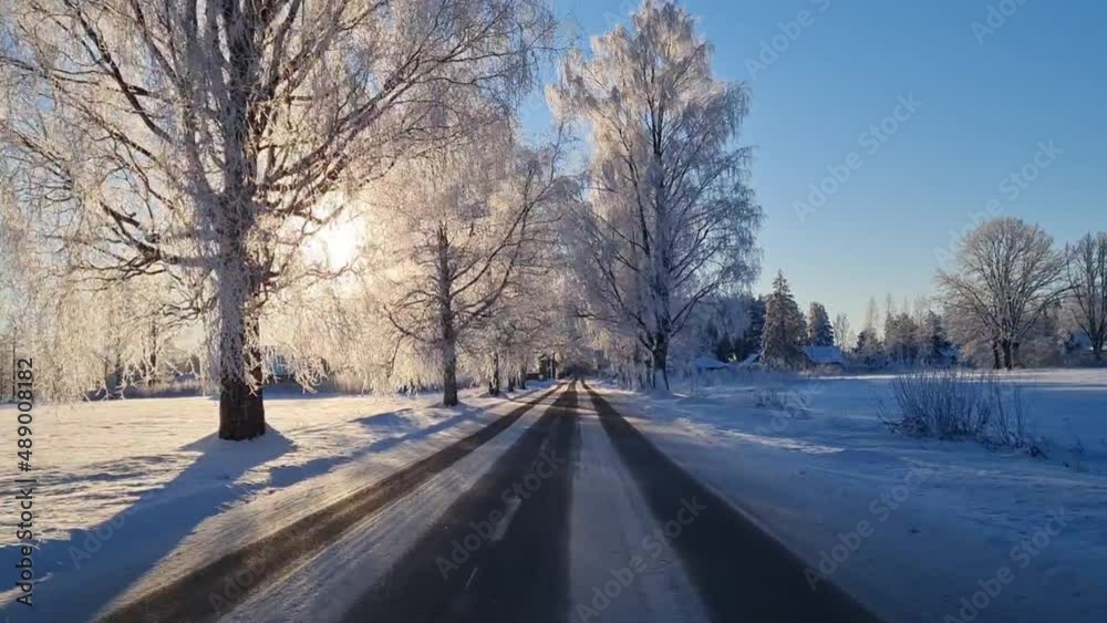 Snow covered asphalt roads. Snow on asphalt. View from the car on the winter road Snow covered asphalt roads. Snow on asphalt. View from the car on the winter road