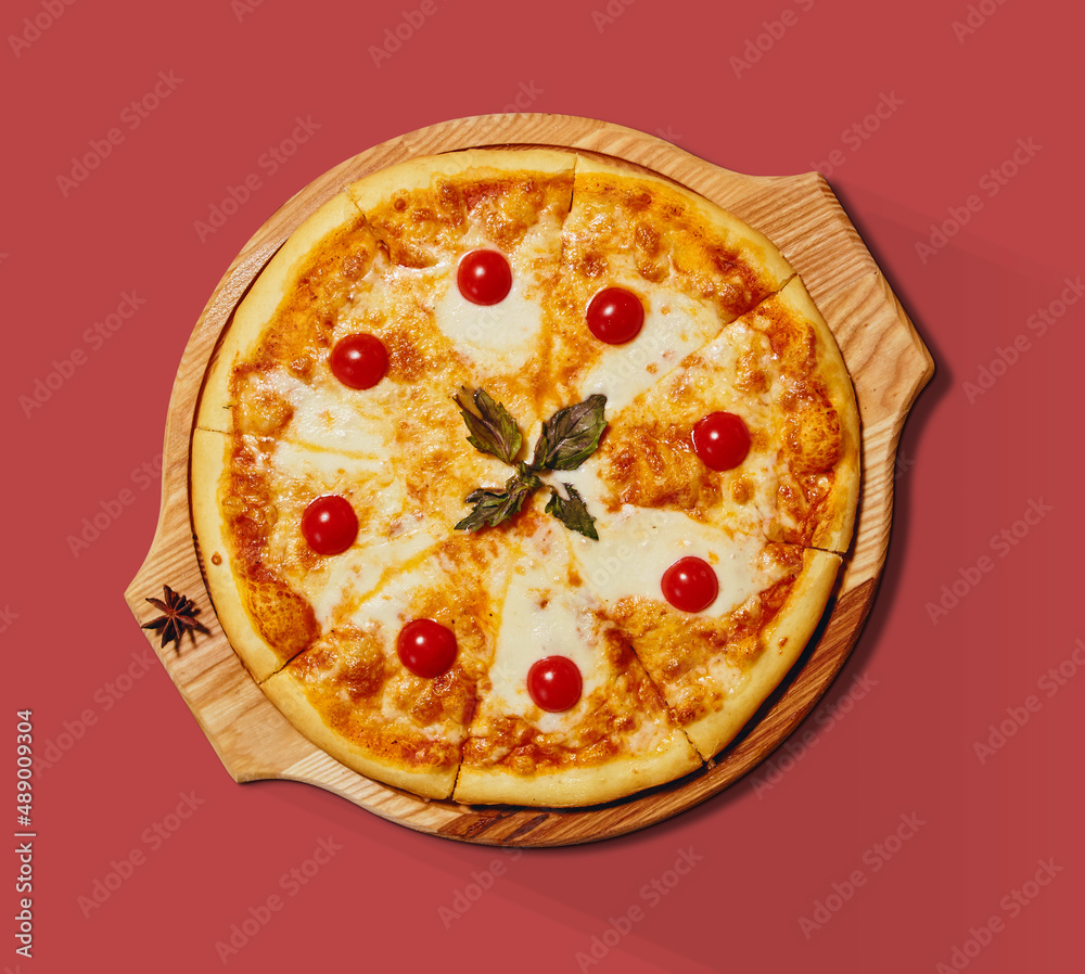 Hot pizza with cheese and tomatoes on a wooden tray isolated from the background Hot pizza with cheese and tomatoes on a wooden tray isolated from the background