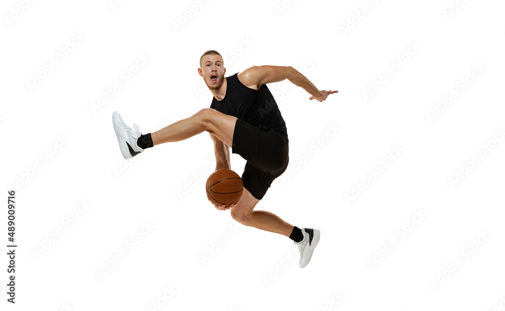 Dynamic portrait of basketball player jumping with ball isolated on white studio background. Sport, motion, activity concepts. Dunk, jam, stuff technic