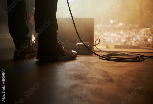 Ready to rock. Cropped shot of a musicians feet on stage at an outdoor music festival. © Mariusz S/peopleimages.com