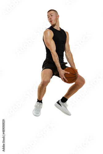Dynamic portrait of muscled man, basketball player jumping with ball isolated on white studio background. Sport, motion, activity concepts.