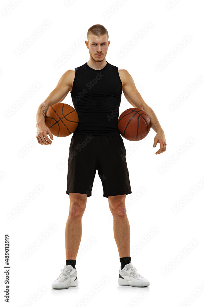 Handsome muscled man, basketball player posing with two balls isolated on white studio background. Sport, motion, activity concepts. Handsome muscled man, basketball player posing with two balls isolated on white studio background. Sport, motion, activity concepts.