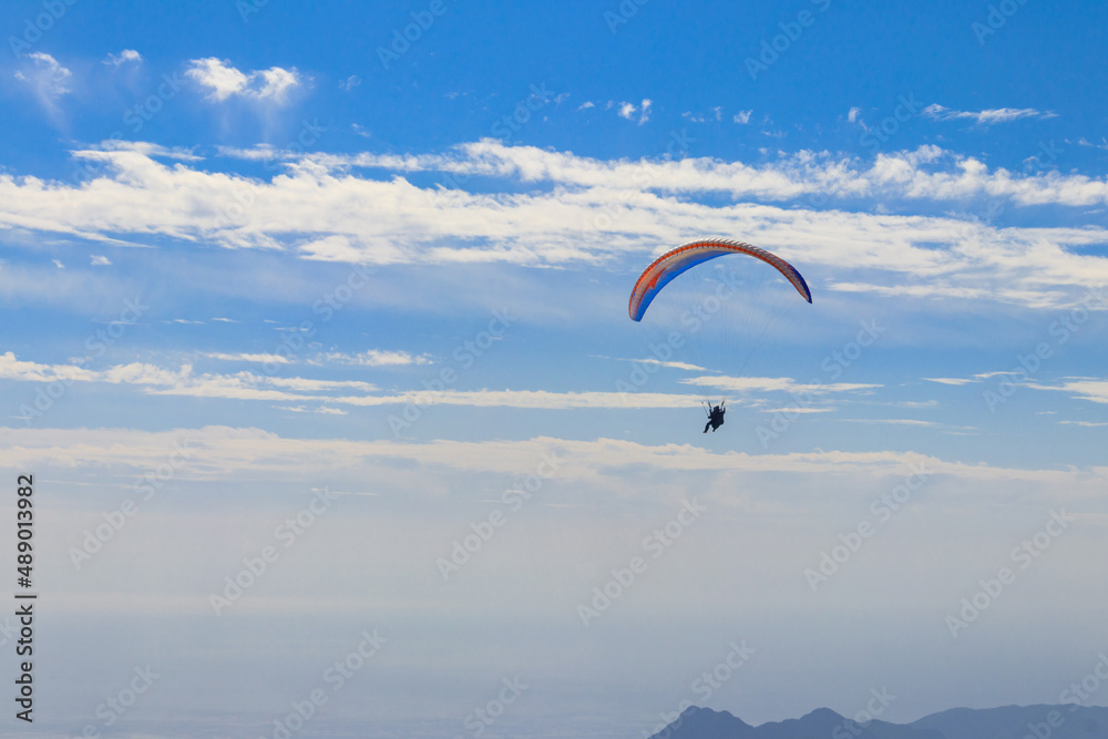 Paragliders flying from a top of Tahtali mountain near Kemer, Antalya Province in Turkey. Concept of active lifestyle and extreme sport adventure Paragliders flying from a top of Tahtali mountain near Kemer, Antalya Province in Turkey. Concept of active lifestyle and extreme sport adventure