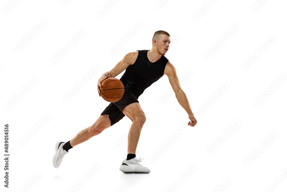 Young muscled man, basketball player practicing with ball isolated on white studio background. Sport, motion, activity concepts. Young muscled man, basketball player practicing with ball isolated on white studio background. Sport, motion, activity concepts.