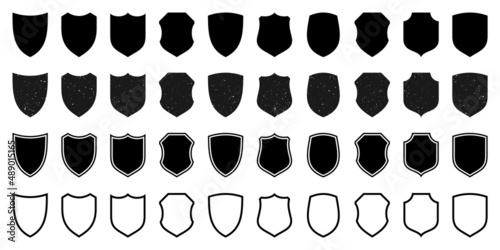 Set of various vintage outlined shield icons. Black heraldic shields with grunge texture. Protection and security symbol, label. Vector illustration.