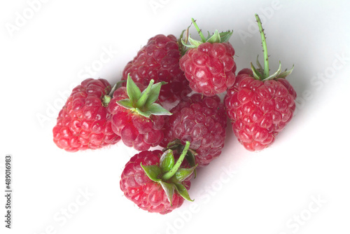 Ripe garden raspberries isolated on a white background.