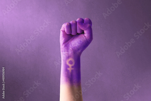 Fotografie, Obraz Raised purple fist of a woman for international women's day and the feminist movement